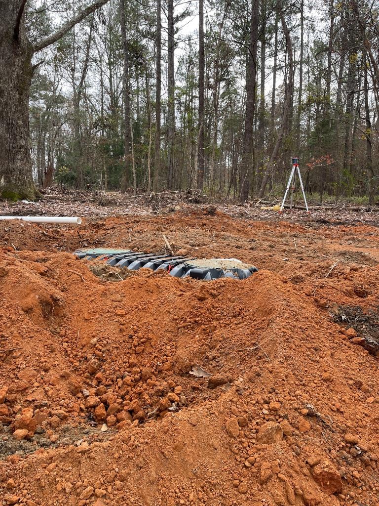 Septic system installation with surveying equipment in West Alabama