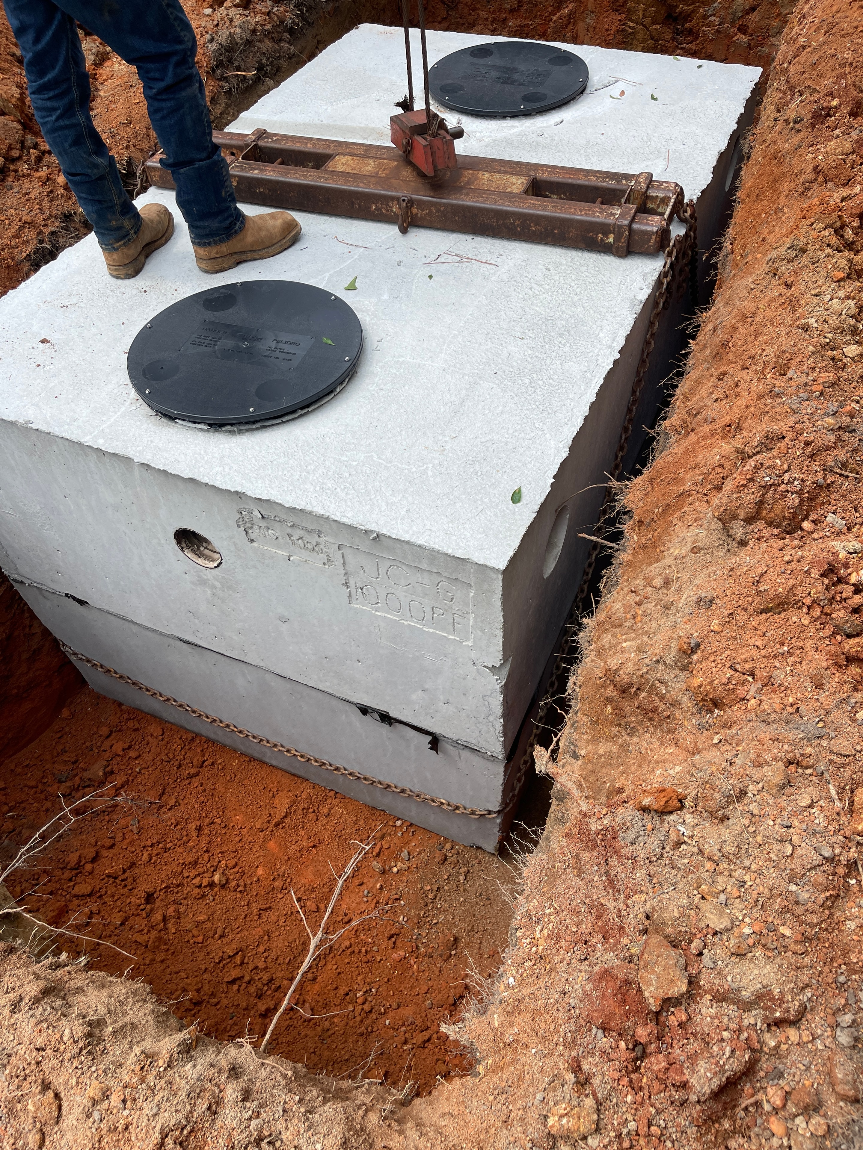 Underground septic tank installation in excavated ground, West Alabama